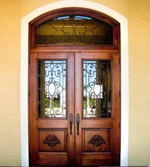 Elliptical-top wood and iron entry door